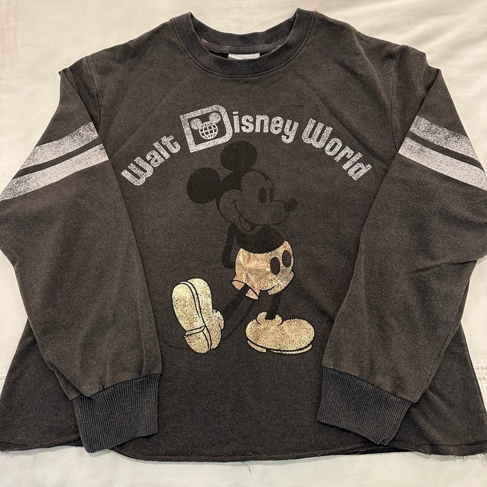 Distressed black Walt Disney World varsity-style long sleeved shirt.